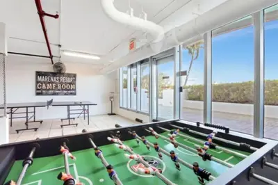 a pool table in a room with windows at Marena Resort in Sunny Isles Beach