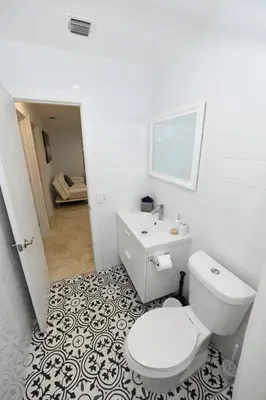 a white bathroom with a toilet and a sink at N61 in Hollywood