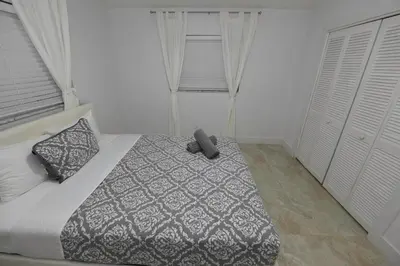 a bedroom with a bed with a black and white comforter at N61 in Hollywood