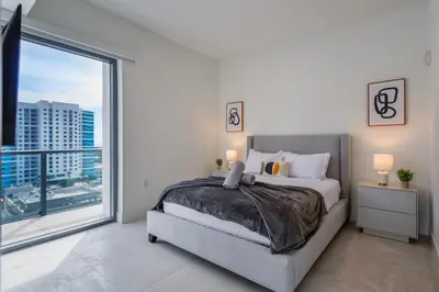 a bedroom with a bed and a large window at Condo with Amazing Views in the Heart of Brickell in Miami