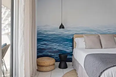 a bedroom with a bed and a painting of the ocean at Bayshore Bliss, Cozy with Water Views of Miami Bay in Miami Beach