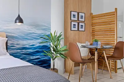a bedroom with a table and chairs next to a bed at Bayshore Bliss, Cozy with Water Views of Miami Bay in Miami Beach