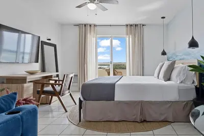 a bedroom with a bed and a table and a desk at Bayshore Bliss, Cozy with Water Views of Miami Bay in Miami Beach