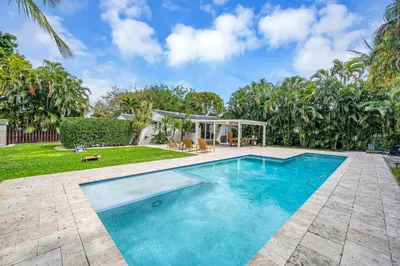 a swimming pool in a yard with a patio at Samadhi - NEW 15 min drive to Ultra, by Newman Hospitality in Miami Shores