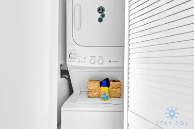 a white refrigerator with a bottle of detergent and snacks at Breathtaking 31st Fl Beachwalk Penthouse View in Hallandale Beach