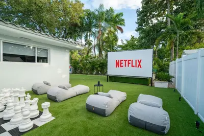 a lawn with some inflatable chairs and a sign at New Luxury Villa Delilah Biscayne Park in Biscayne Park