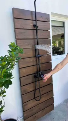 a person with a hose attached to a wooden door at Pool! Best location! Steps to the water! Kid friendly! in Miami