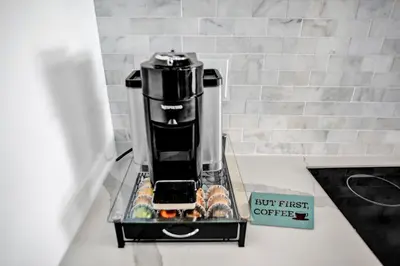 a coffee machine sitting on a counter with a book at Modern 4 Bedroom -Kosher - Heated Pool - Game Room in Hollywood