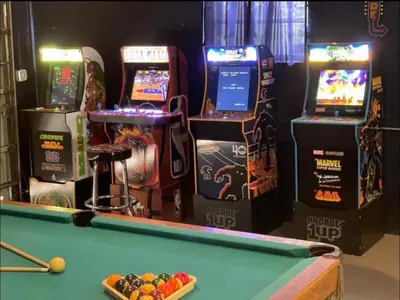 a room with a pool table and arcade machines at Modern 4 Bedroom -Kosher - Heated Pool - Game Room in Hollywood