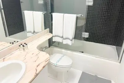 a bathroom with a sink and a toilet and a tub at Miami Beach Apartments by MiaRentals in Miami Beach