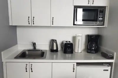 a kitchen counter with a sink and a microwave at Miami Beach Apartments by MiaRentals in Miami Beach