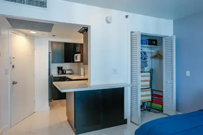 a kitchen and living room with a counter in a room at Miami Beach Apartments by MiaRentals in Miami Beach