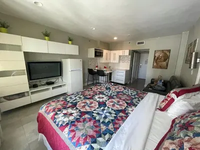 a bedroom with a large bed with a quilt on it at Oceanfront Miami Beach Studio 925 in Miami Beach