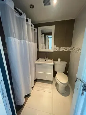 a bathroom with a toilet and a sink at Oceanfront Miami Beach Studio 925 in Miami Beach