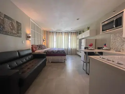 a living room with a couch and a bed in a room at Oceanfront Miami Beach Studio 925 in Miami Beach