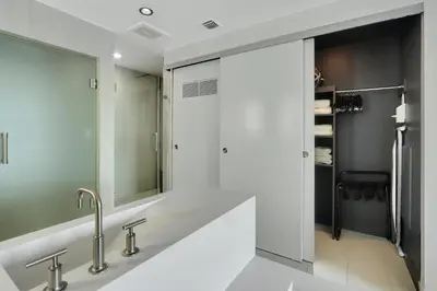 a bathroom with two sinks and a mirror at Nautica - Ocean View & Rooftop Pools! by Newman Hospitality in Fort Lauderdale
