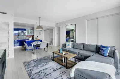 a living room with a couch and a table at Nautica - Ocean View & Rooftop Pools! by Newman Hospitality in Fort Lauderdale