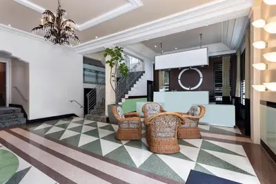a living room with wicker chairs and a table at Roami at Hotel Astor in Miami Beach