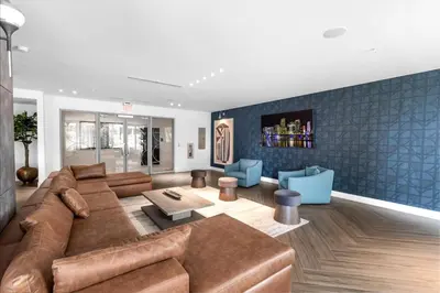 a living room with a brown couch and blue walls at Miami Magic Vibrant 2 Bedroom with Free Parking in Miami