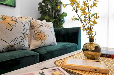a living room with a table with a vase and a couch at Miami Magic Vibrant 2 Bedroom with Free Parking in Miami