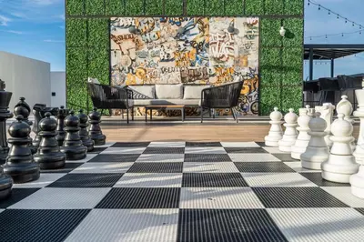 a chess board with two chairs and a mural at Miami Magic Vibrant 2 Bedroom with Free Parking in Miami