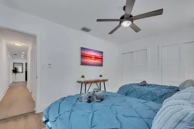 a bedroom with two beds and a ceiling fan at Gated Villa Blanca 5BR 3BA with Heated Pool & BBQ in Miami