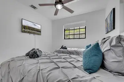 a bedroom with a bed and a ceiling fan at Gated Villa Blanca 5BR 3BA with Heated Pool & BBQ in Miami