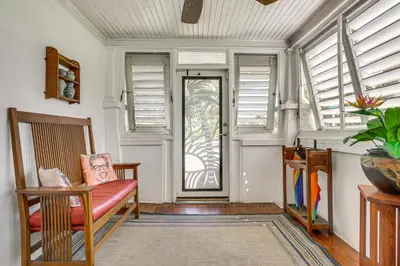 a living room with a couch and a door with windows at Fort Lauderdale Oasis with Pool about 2 Mi to Beach! in Fort Lauderdale