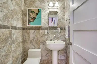 a bathroom with a toilet and a sink at Fort Lauderdale Oasis with Pool about 2 Mi to Beach! in Fort Lauderdale