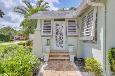 a house with a door with a drawing on it at Fort Lauderdale Oasis with Pool about 2 Mi to Beach! in Fort Lauderdale
