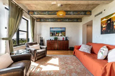 a living room with a orange couch and chairs at The Netherland by MIAMI BEACH OCEAN RENTAL in Miami Beach