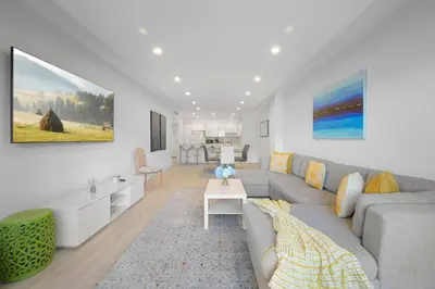 a living room with a couch and a table at Comfortable and broad apartment in O-Reserve near on the beach in Sunny Isles Beach