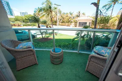 a balcony with wicker chairs and a bowl on it at Comfortable and broad apartment in O-Reserve near on the beach in Sunny Isles Beach