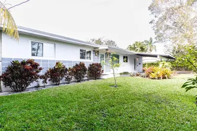 a house with a green lawn in front of it at Tropical Private Oasis Mins from Beach & Downtown in Miami