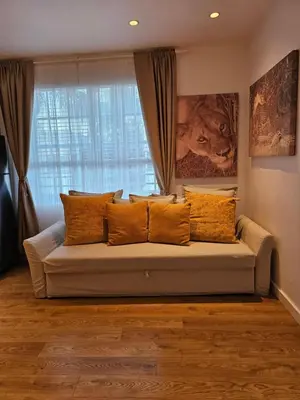 a couch in a living room with a window at Bright 1BedRoom RENOVATED NEAR THE BEACH (4PPL) in Miami Beach