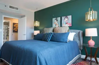 a bedroom with a blue bed and a green wall at Coconut Grove 2 bedroom Apartment Amazing Views Includes Parking in Miami