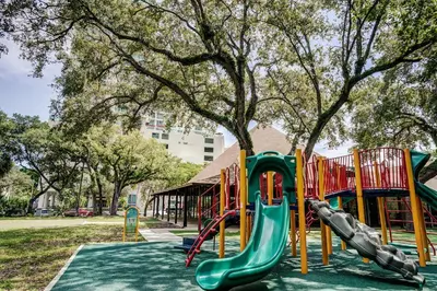 a playground with a slide in a park at Direct Bayview One Bedroom Condo in Coconut Grove Includes parking in Miami