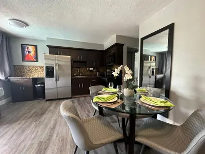 a kitchen and dining room with a table and chairs at Sheridan Suites Apartments in Dania Beach
