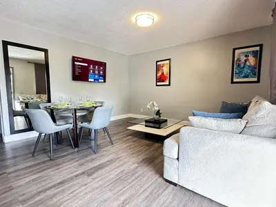 a living room with a couch and a table at Sheridan Suites Apartments in Dania Beach