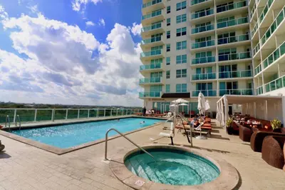 a swimming pool in front of a large building at Coconut Grove 10th Fl Studio Parking Included in Miami