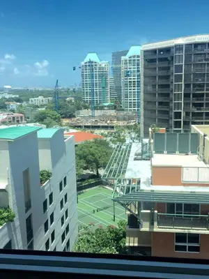 a view of a tennis court in a city at Adorable 12th Floor Standard Unit Parking Included in Miami