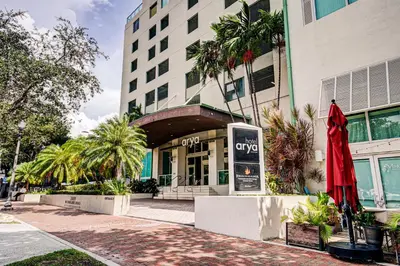 a building with a red umbrella in front of it at Adorable 12th Floor Standard Unit Parking Included in Miami