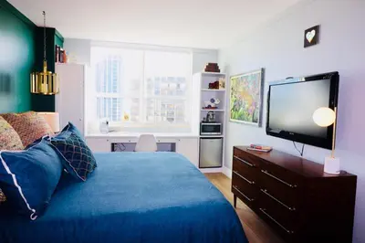 a bedroom with a blue bed and a flat screen tv at Adorable 12th Floor Standard Unit Parking Included in Miami
