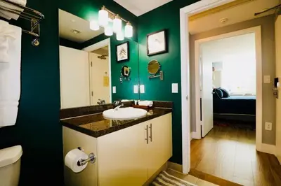 a bathroom with a sink and a green wall at Gorgeous Coconut Grove 3 bedroom Condo with amazing views Parking Included in Miami