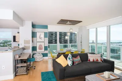 a living room with a couch and a table at Gorgeous Coconut Grove 3 bedroom Condo with amazing views Parking Included in Miami