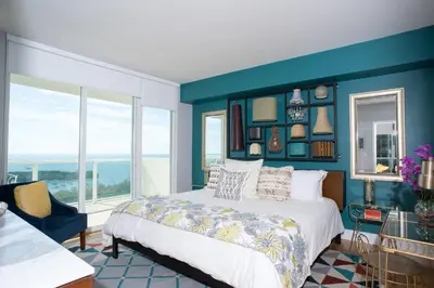 a bedroom with a bed and a blue wall at Gorgeous Coconut Grove 3 bedroom Condo with amazing views Parking Included in Miami
