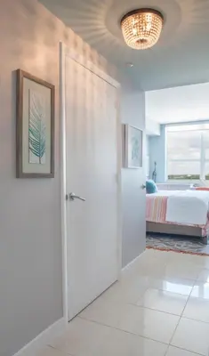a bedroom with a door leading to a bed at Coconut Grove 10th Floor private unit Parking Included in Miami