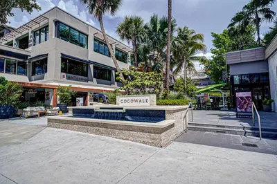 a building with a sign in front of it at Deluxe Studio in Coconut Grove City and Bay views Includes Parking in Miami
