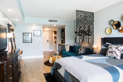 a bedroom with a bed and a living room at Deluxe Studio in Coconut Grove City and Bay views Includes Parking in Miami