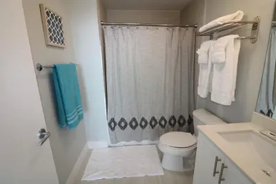 a small bathroom with a toilet and a shower at Connecting Rooms-Coconut Grove 21st Floor Parking Included in Miami